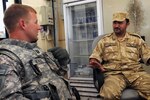 U.S. Army Capt. Dewitt Revels, from Jacksonville, Fla., meets with a Qatari soldier at Camp As Sayliyah, Qatar, April 19. The 53rd Infantry Brigade Combat Team, the largest Army National Guard unit in Florida, reported for duty at Camp Buehring, Kuwait, in early March. Bravo Troop, 1st Squadron, 153rd Cavalry Regiment, 53rd IBCT soldiers quickly departed the following week to take over force protection from contracting firms at Camp As Sayliyah. "Everyone is going to be enriched by this experience," said Dewitt, Bravo Troop commander.
