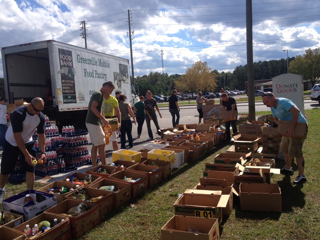 Marines and sailors with 8th Communication Battalion, II Marine Headquarters Group volunteered for the local Salvation Army food drive in Jacksonville, N.C., Oct. 17.  All of the food was donated by local distributors.
