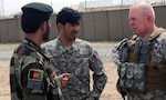 Army Command Sgt. Maj. Jim Brown, the command sergeant major for the Indiana National Guard's Regional Core Training Team 2, speaks with Afghan National Army Sgt. Maj. Zar M. Sherzad, sergeant major for the ANA's 203rd Thunder Corps, 3rd Brigade, at Forward Operating Base Vulcan, Ghazni province, Afghanistan, April 14, 2010. Brown and Sherzad both spoke at a conference on the development of the ANA's non-commissioned officer program on FOB Vulcan earlier in the day.