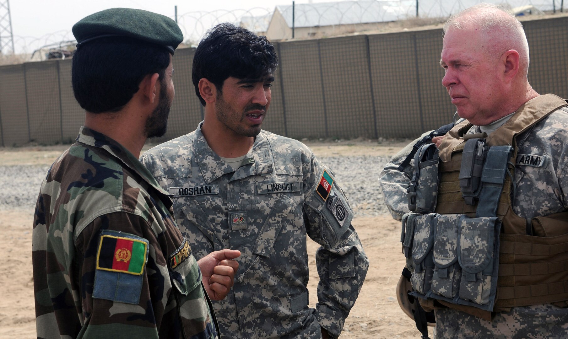 Army Command Sgt. Maj. Jim Brown, the command sergeant major for the Indiana National Guard's Regional Core Training Team 2, speaks with Afghan National Army Sgt. Maj. Zar M. Sherzad, sergeant major for the ANA's 203rd Thunder Corps, 3rd Brigade, at Forward Operating Base Vulcan, Ghazni province, Afghanistan, April 14, 2010. Brown and Sherzad both spoke at a conference on the development of the ANA's non-commissioned officer program on FOB Vulcan earlier in the day.