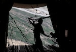 Senior Master Sgt. Thomas Kelly retrieves static lines after his second airdrop of the day over Afghanistan March 2, 2010. Kelly is deployed from the Maryland Air National Guard's 135th Airlift Squadron, based in Baltimore, Md.