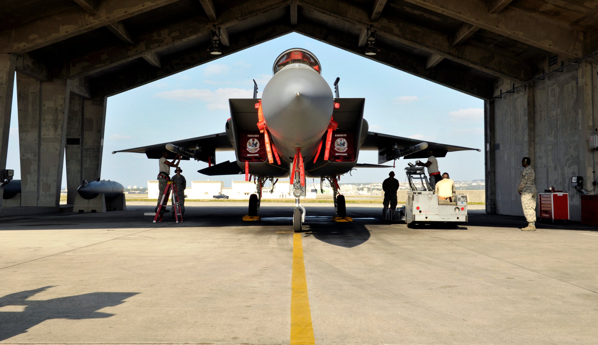 A U.S. Air Force weapons load crew team from the 67th Aircraft Maintenance Unit loads weapons onto an F-15 Eagle during a quarterly weapons load competition on Kadena Air Base, Japan, Jan. 5, 2015. The competition evaluated safety, reliability and effectiveness while adhering to technical data and explosive safety. (U.S. Air Force photo by Naoto Anazawa)