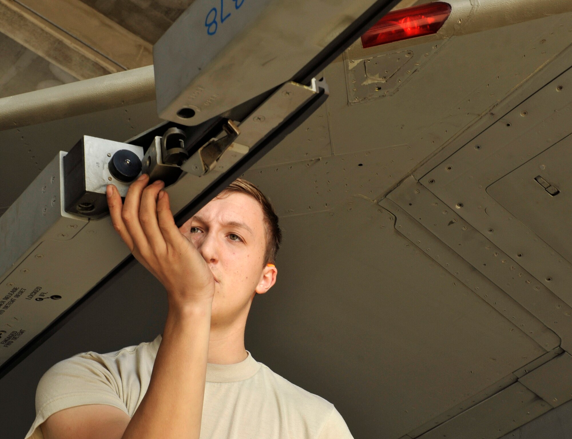 U.S. Air Force Airman 1st Class Adam Pratschler, 18th Aircraft Maintenance Squadron weapons load crew member, configures an LAU-128 missile launcher  during a quarterly weapons load competition on Kadena Air Base, Japan, Jan. 5, 2015. The quarterly competition encourages the crews competing to move quicker, think faster and push harder while adhering to technical data to become the Load Crew of the Quarter and have the opportunity to compete for Load Crew of the Year. (U.S. Air Force photo by Naoto Anazawa)