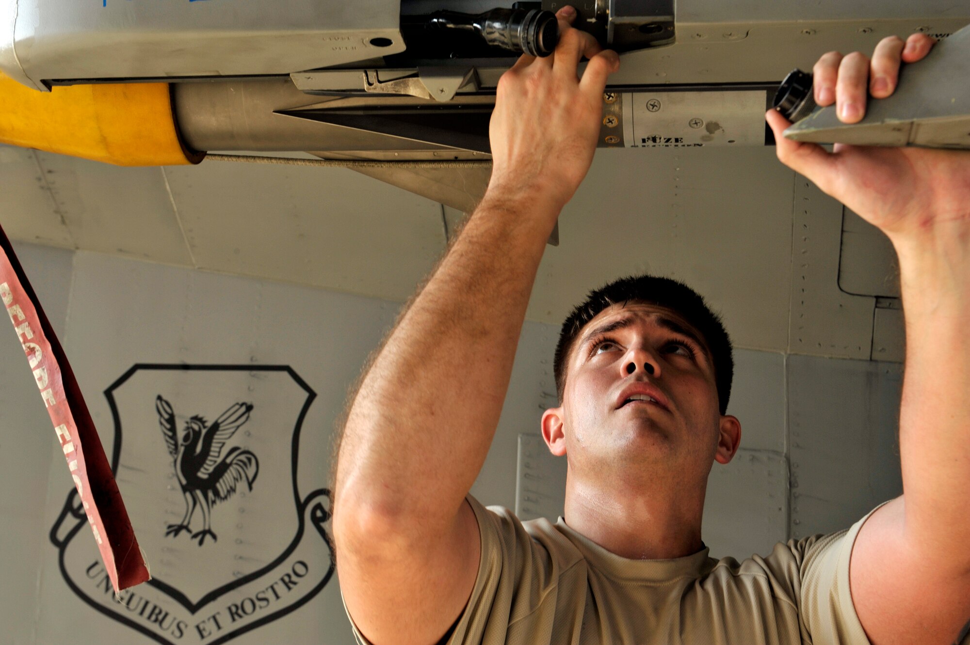 U.S. Air Force Staff Sgt. Andrew Gyke, 18th Maintenance Operations Squadron weapons load crew chief, secures an AIM-9L/M Sidewinder missile during a quarterly weapons load competition on Kadena Air Base, Japan, Jan. 5, 2015. The weapons load competition is designed to enhance Airmen's skills while operating under pressure. (U.S. Air Force photo by Naoto Anazawa)
