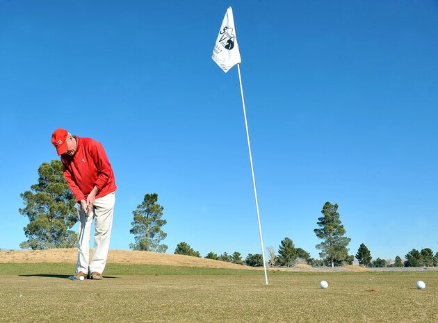 Ed Joyce, a Sunrise Vista patron, putts a golf ball on the Sunrise Vista Golf Course at Nellis Air Force Base, Nev., Jan. 7, 2015. The golf course will be undergoing changes in order to implement various cost saving initiatives. These initiatives include analyzing community needs, validating fees and assessing customer-focused programs in an effort to increase revenue and profitability. (U.S. Air Force photo by Airman 1st Class Rachel Loftis)