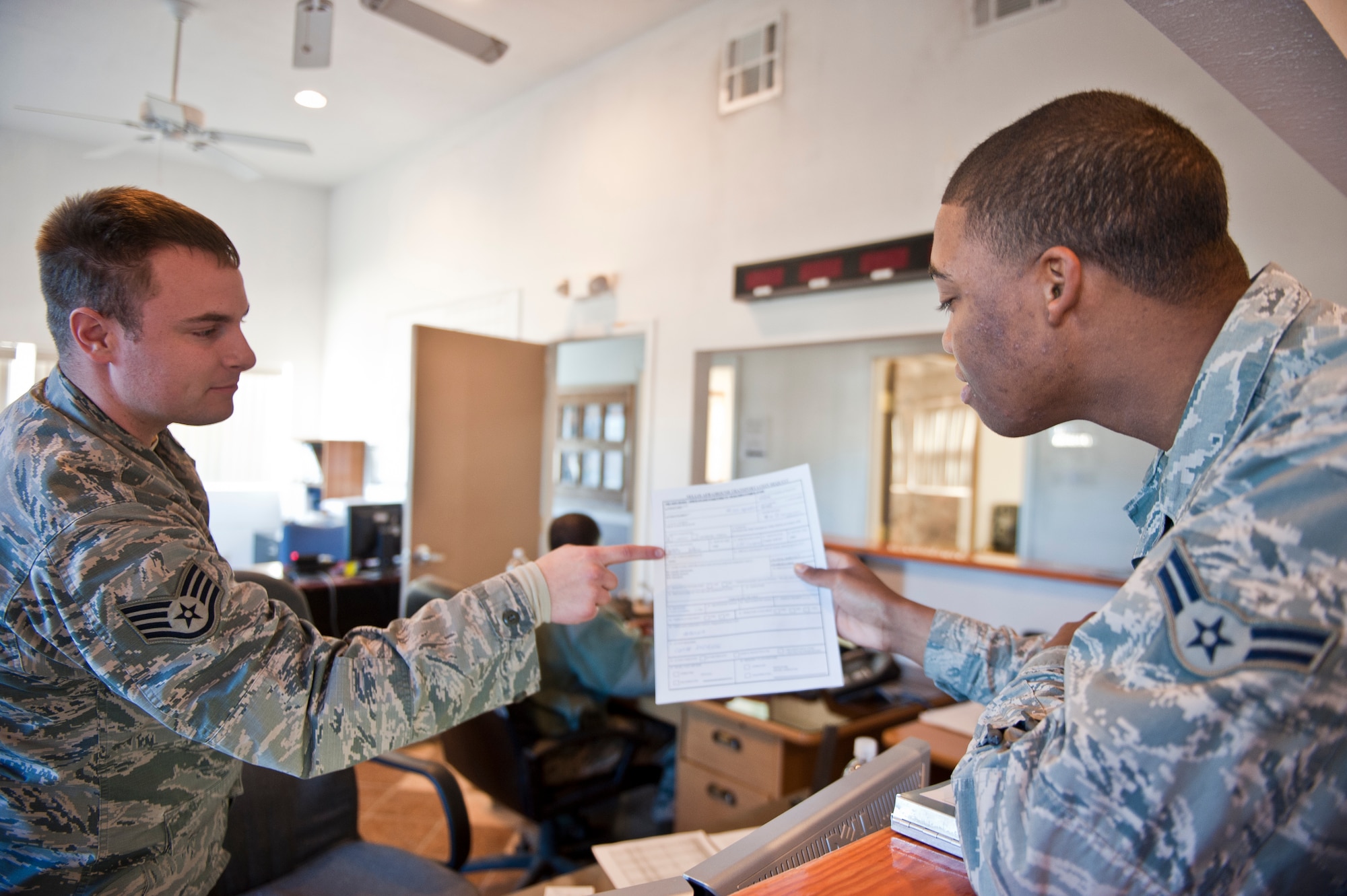 Staff Sgt. William Steenland, left, and Airman 1st Class Marcus Johnson, 99th Logistics Readiness Squadron vehicle operations center, review an aircrew log at the vehicle operations center on Nellis Air Force Base, Nev., Jan. 6, 2015. The aircrew log keeps track of flight takeoff and landing times, so vehicle dispatchers can send Airmen to drop pilots off and pick them up from their aircraft. (U.S. Air Force photo by Airman 1st Class Mikaley Towle)