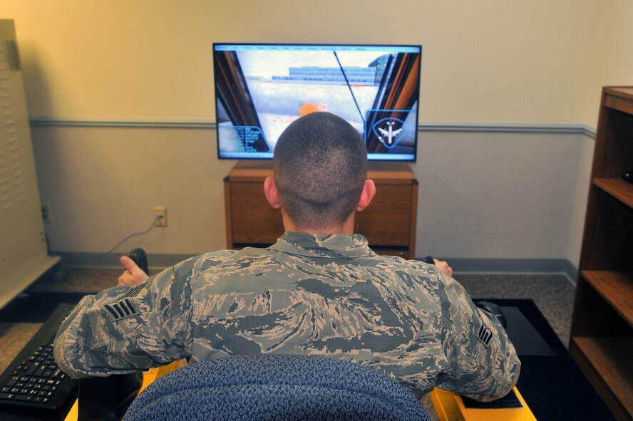 Staff Sgt. Tyler Mousner, 92nd Maintenance Group Maintenance Qualification Training Program instructor, uses the deicing simulator Dec. 3, 2014 at Fairchild Air Force Base, Wash. The recently-installed simulator increases training by allowing students to learn how to deice a plane without using costly resources.  (U.S. Air Force photo/Staff Sgt. Veronica Montes)