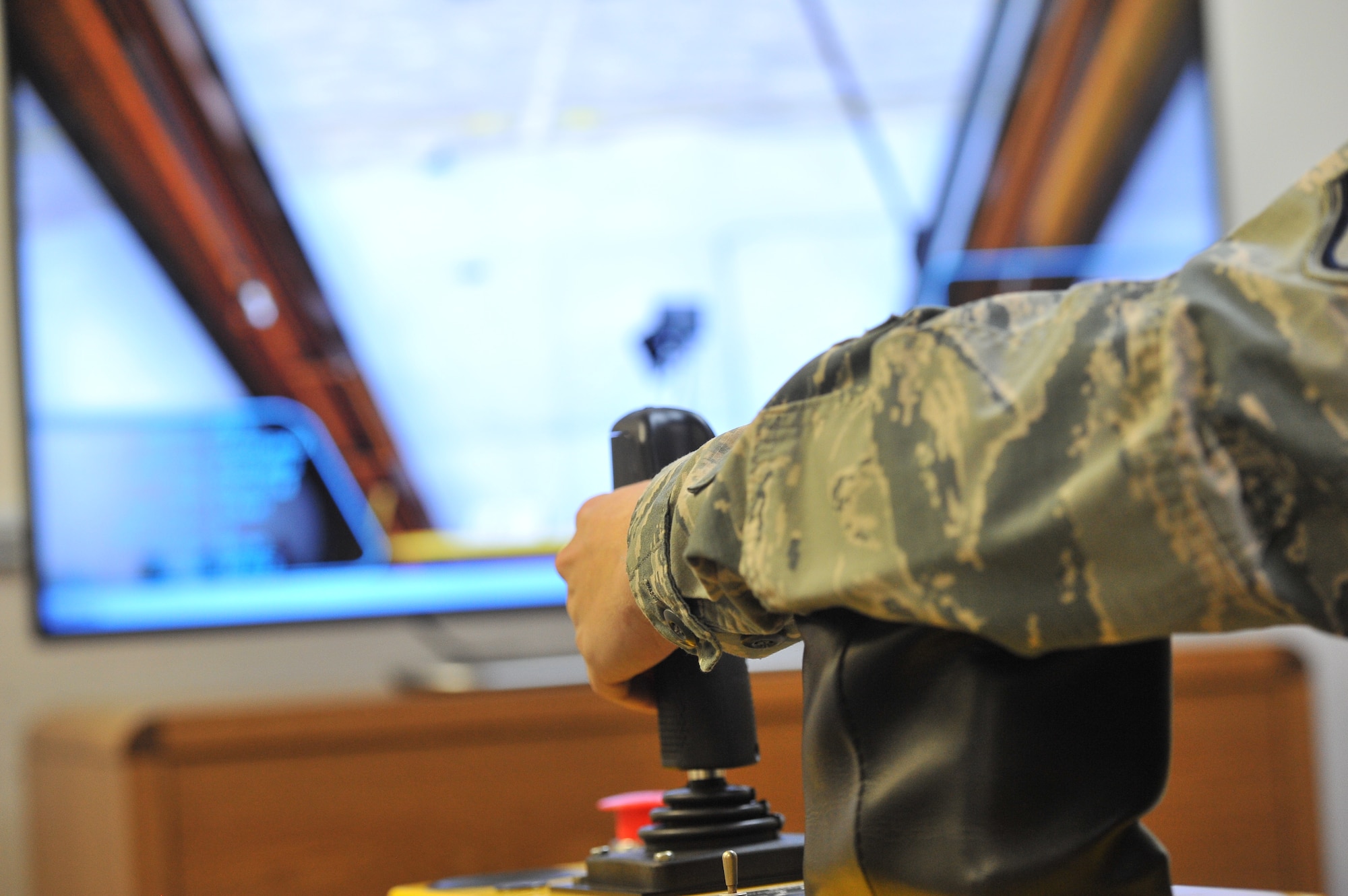 Staff Sgt. Tyler Mousner, 92nd Maintenance Group Maintenance Qualification Training Program instructor, uses the deicing simulator Dec. 3, 2014 at Fairchild Air Force Base, Wash. The simulator was recently installed and will allow Airmen to train without using deicing equipment and use expendable resources. All new, and many currently assigned to the 92nd Aircraft Maintenance Squadron, and some new Airmen to the 92nd Maintenance Squadron will train on the new simulator. (U.S. Air Force photo/Staff Sgt. Veronica Montes)