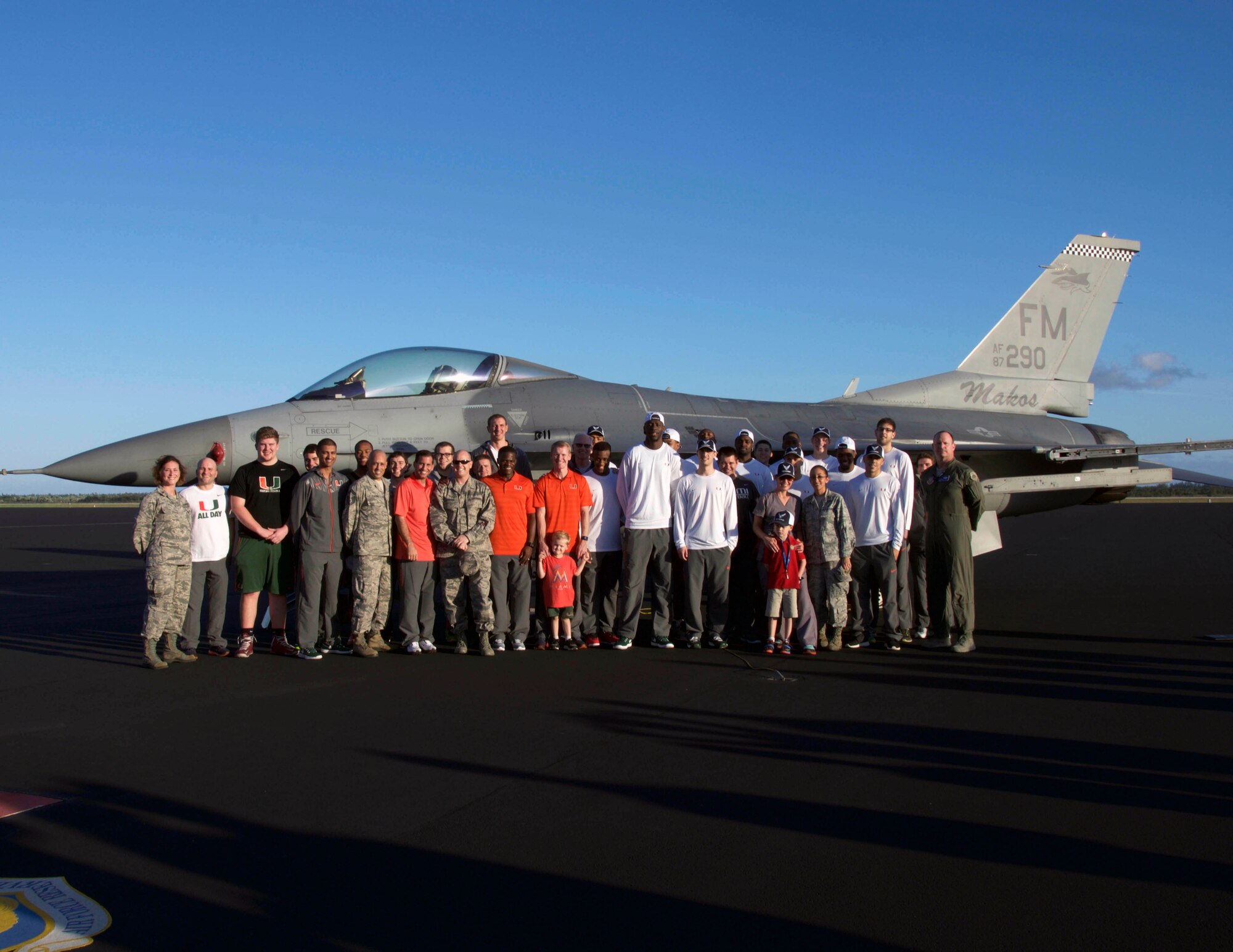 Members of the University of Miami men’s basketball team and the 482nd Fighter Wing pose for a picture in front of an F-16C during the “Night out with the Hurricanes” event for military members and their families at Homestead Air Reserve Base, Fla., on Jan. 6. (U.S. Air Force photo/Senior Airman Jaimi Upthegrove)