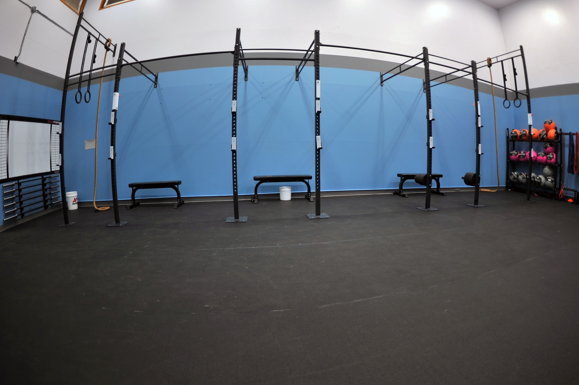 ALTUS AIR FORCE BASE, Okla. – The first of two rooms that house new equipment waits for its first patrons inside the fitness center Jan. 7, 2014. The equipment in the newly added Functional Fitness Center includes two Olympic weightlifting platforms, five rowers, a 30 foot pull-up rig, 20 barbells, more than 2,500 lbs in rubber plates, kettlebells and wall balls. Altus AFB will open the new Functional Fitness Center beginning Jan. 8, 2014. The workout center is located inside the Altus AFB Fitness Center and will be open for use Monday-Friday from 5 a.m. to midnight and Saturday and Sunday from 8 a.m. – 11 p.m. (U.S. Air Force photo by Senior Airman Dillon Davis/Released)