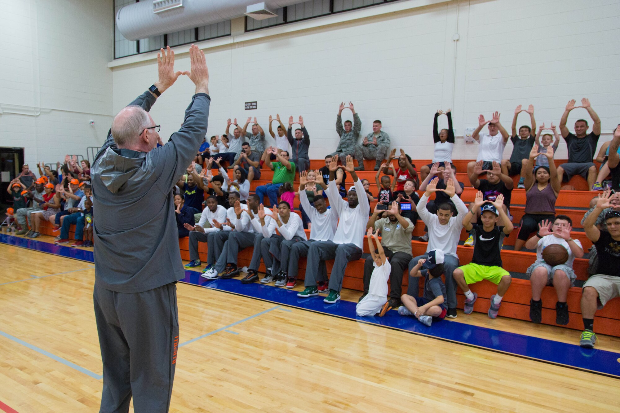 University of Miami men’s basketball coach Jim Larrañaga leads everyone in displaying the  “U” during the “Night out with the Hurricanes” event for military members and their families at the Sam Johnson Fitness Center, Homestead Air Reserve Base, Fla. on Jan. 6(Air Force photo/TSgt Lionel Castellano)