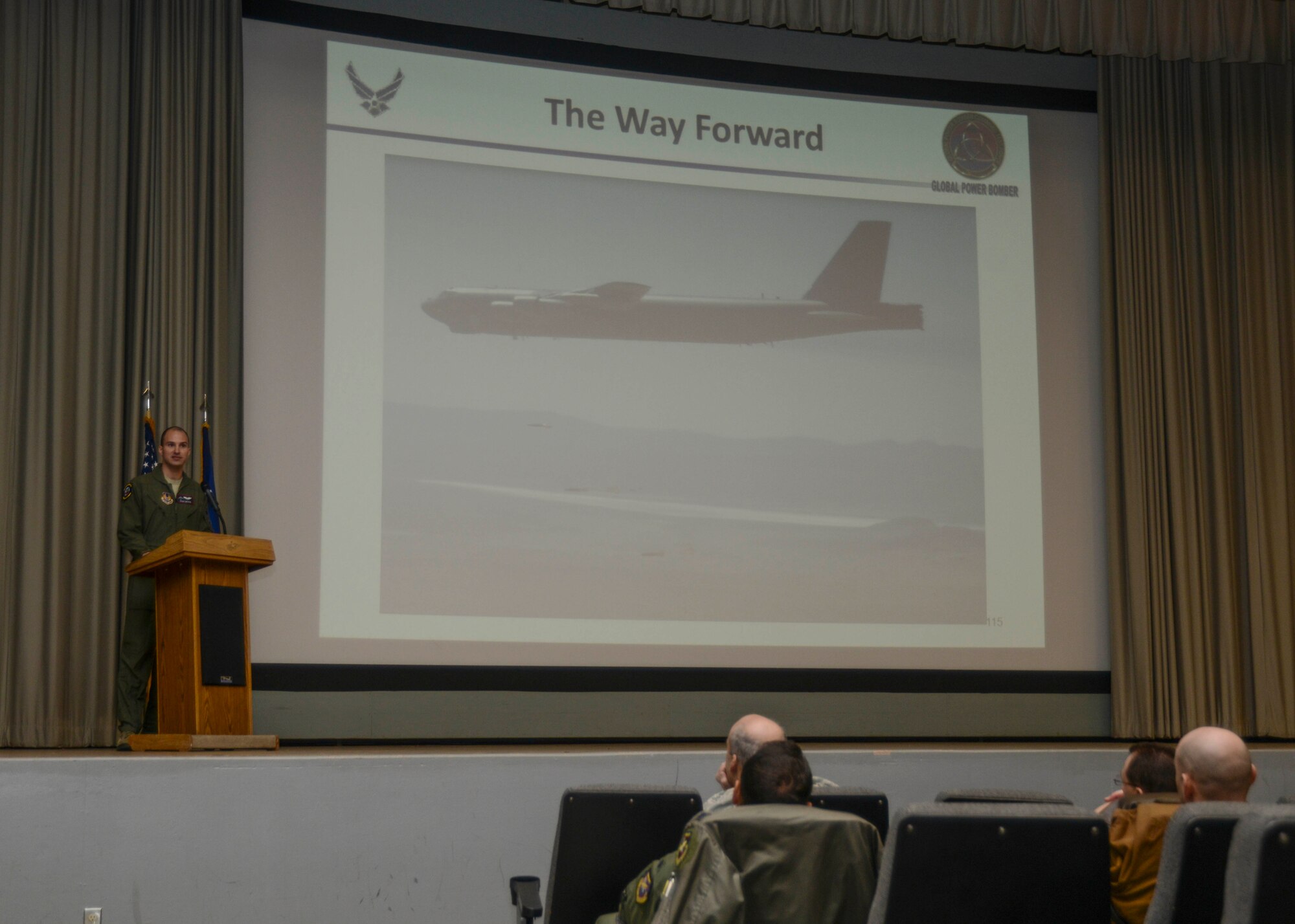 Capt. Ryan Hefron, 419th Flight Test Squadron, talked about the B-52 Quickstrike Mine Test program during a Back in the Saddle briefing in the base theater Jan. 5. Back in the Saddle is an annual event that officially kicks off the new year for Edwards and sets the tone for the way forward.  (U.S. Air Force photo by Rebecca Amber) 