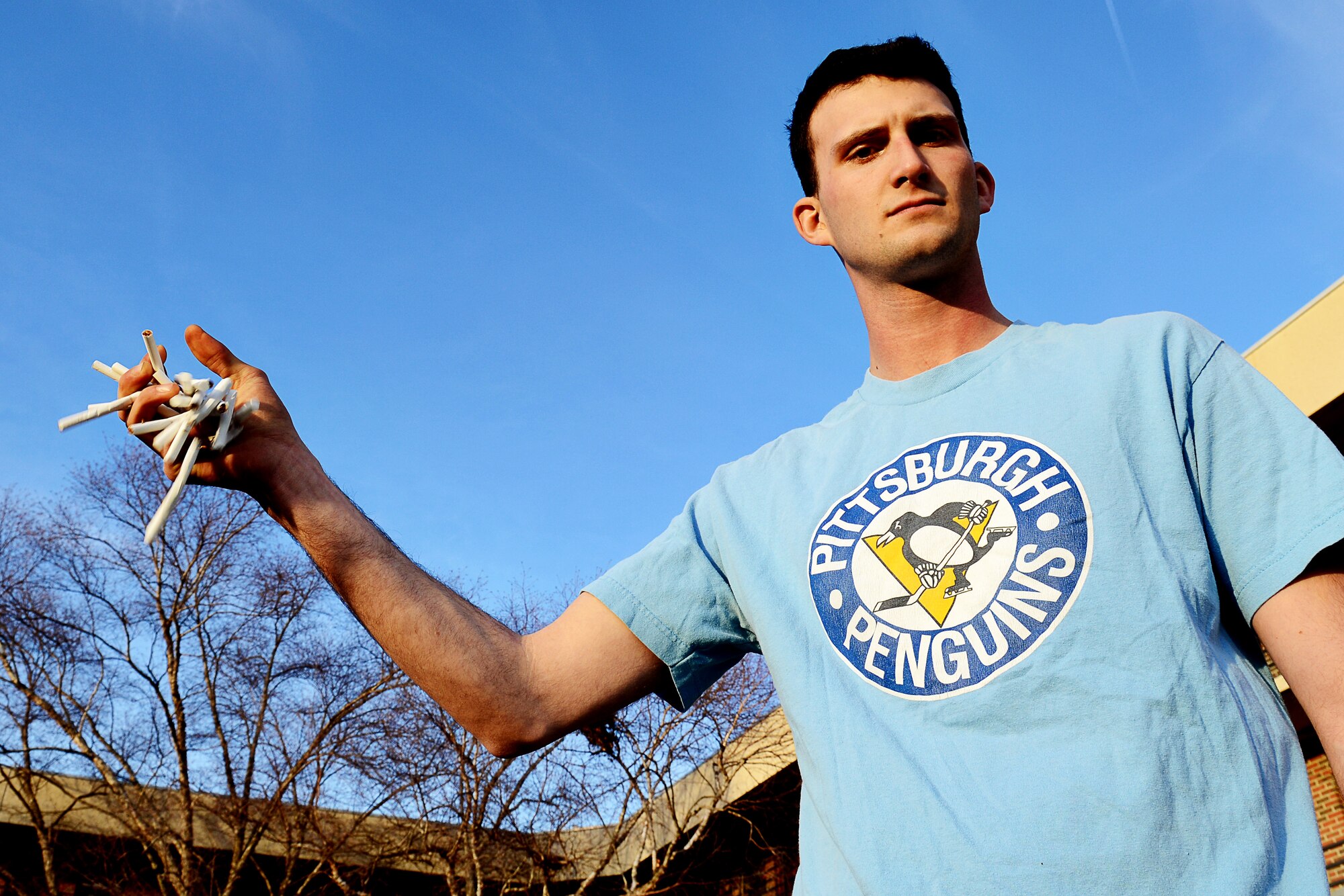 U.S. Air Force Airman 1st Class Brandon Ritenour, 633rd Civil Engineer Squadron heavy equipment operator, drops a handful of cigarettes at Langley Air Force Base, Va., Jan. 6, 2015. Ritenour’s resolution for the new year is to quit smoking. He says his friends and girlfriend will continue to support him to never light another cigarette again. (U.S. Air Force photo illustration by Airman 1st Class Devin Scott Michaels/Released)