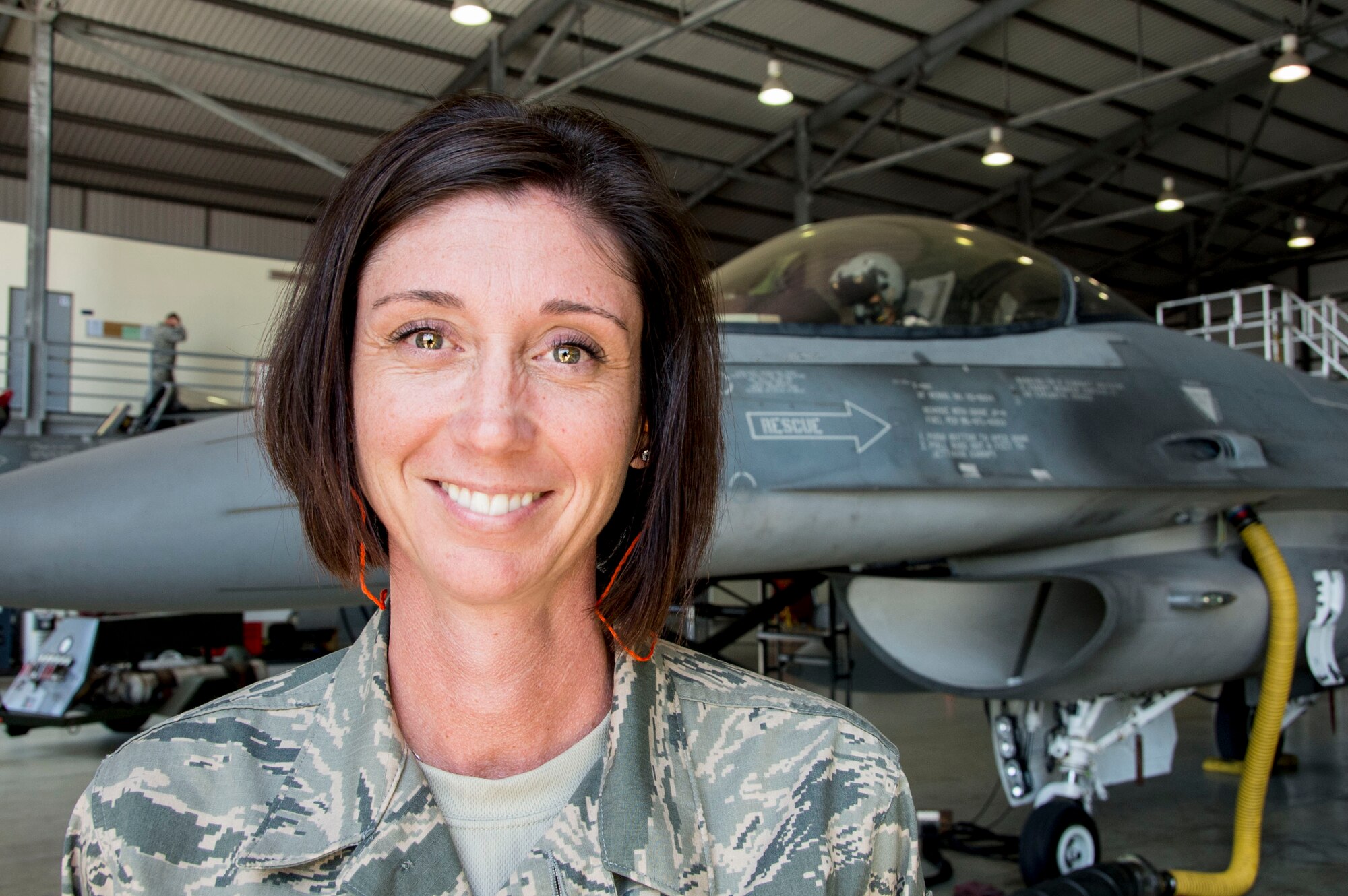 Master Sgt. Cari Webb, 563rd Operations Support Squadron Aircrew Flight Equipment Superintendent, smiles during a preflight function checks on Dec. 03, 2014, while in Chile. Webb was a member of an Air Forces Southern Mobile Training Team who took part in a four-week training session, which took place in Chile and focused on perfecting maintenance procedures and the use of night vision goggles. (U.S. Air Force photo by Staff Sgt. Adam Grant/Released)