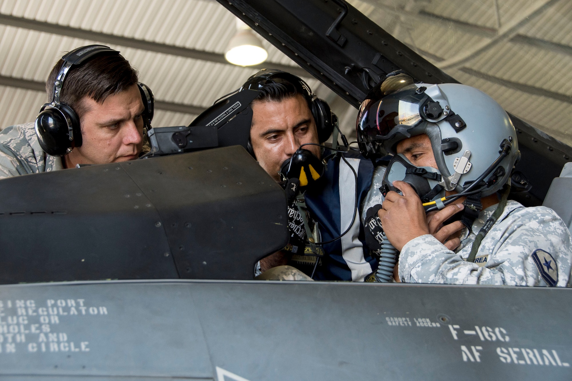 Tech. Sgt. Jeffrey Kelley, 372nd Training Squadron Detachment 12 F-16 Avionics Instructor, observes while members of the Fuerza Aérea de Chile (Chilean air force) perform preflight functions checks on Dec. 03, 2014, in Chile. During the four-week training session, which took place in Chile and focused on perfecting maintenance procedures and the use of night vision goggles, Air Forces Southern members were able to successfully meet all training objectives while establishing a very strong partnership. (U.S. Air Force photo by Staff Sgt. Adam Grant/Released)