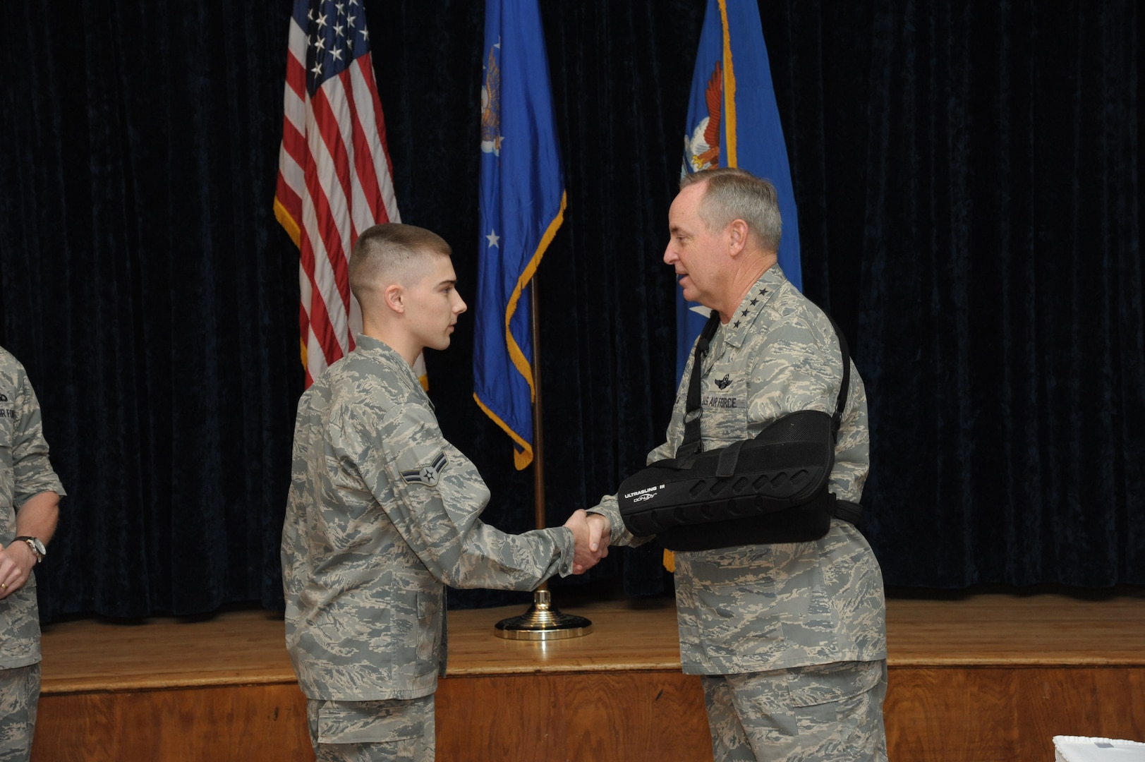 Air Force Chief of Staff Gen. Mark A. Welsh III (right) presents a CSAF coin to Airman 1st Class Lane Rabern for his contributions to the Air Force mentoring program Dec. 9 at Joint Base San Antonio-Randolph. (U.S. Air Force photo by Joel Martinez)