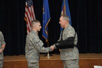 Air Force Chief of Staff Gen. Mark A. Welsh III (right) presents a CSAF coin to Airman 1st Class Lane Rabern for his contributions to the Air Force mentoring program Dec. 9 at Joint Base San Antonio-Randolph. (U.S. Air Force photo by Joel Martinez)