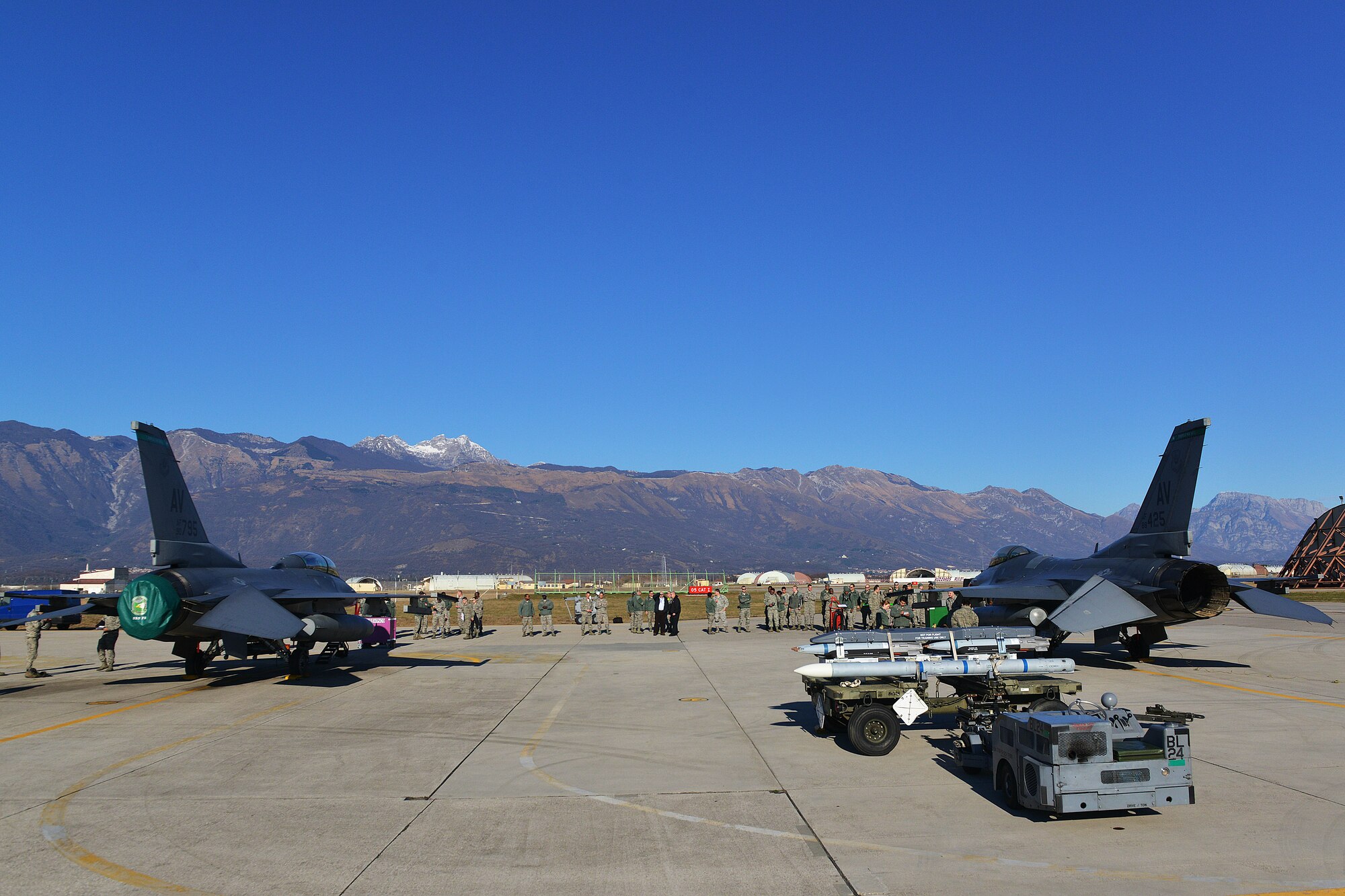 Spectators gather around two F-16 Fighting Falcons before the start of a quarterly weapons load competition, Jan. 6, 2015, at Aviano Air Base, Italy. Load crew competitions are held quarterly and annually to determine the best load crews. (U.S. Air Force photo/Airman 1st Class Ryan Conroy)