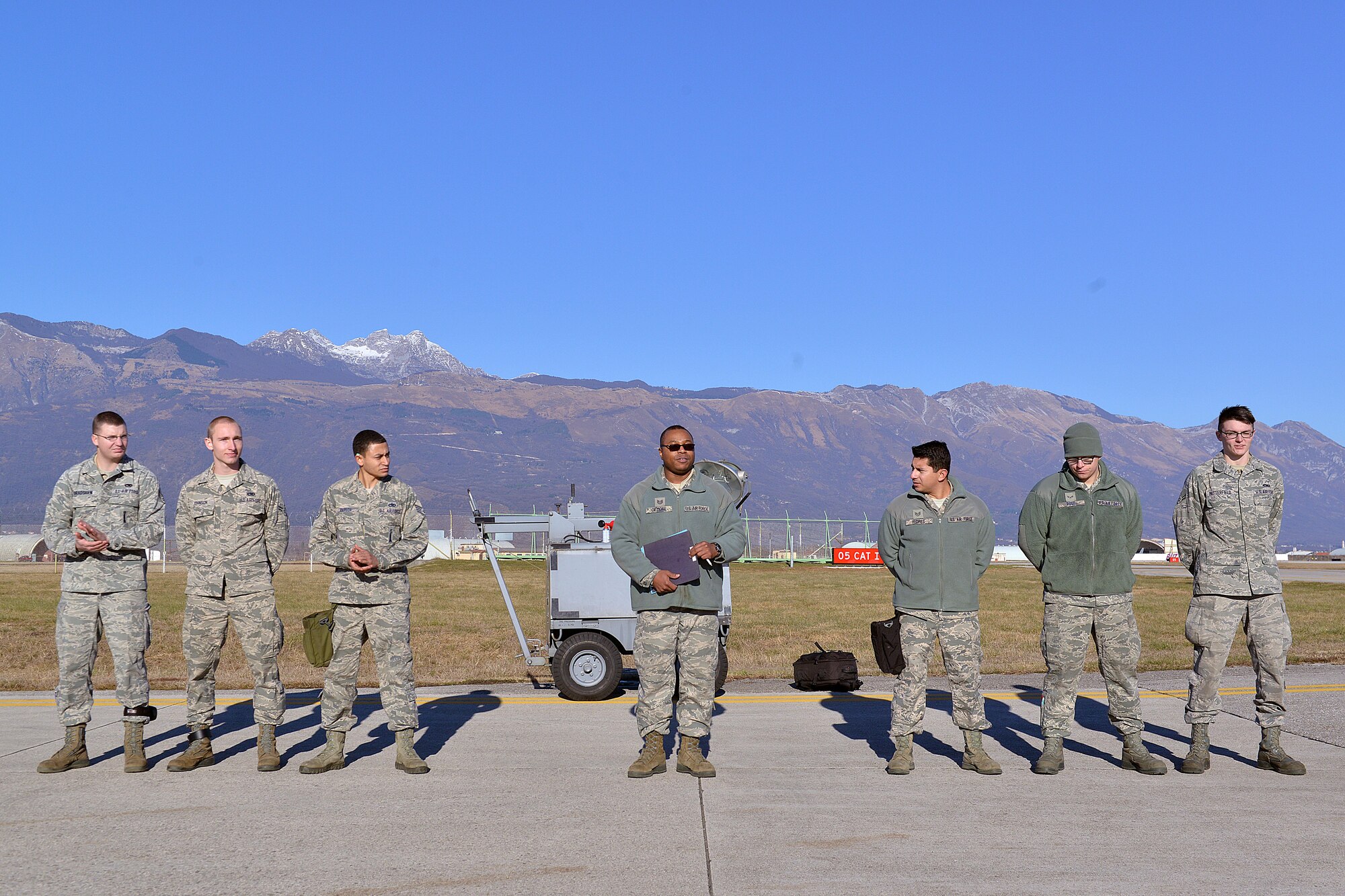 Two 31st Aircraft Maintenance Squadron weapons load crews await the start of a quarterly weapons load competition, Jan. 6, 2015, at Aviano Air Base, Italy. Load crews from the squadron competed for the base’s top weapon loading honors during the event. (U.S. Air Force photo/Airman 1st Class Ryan Conroy)