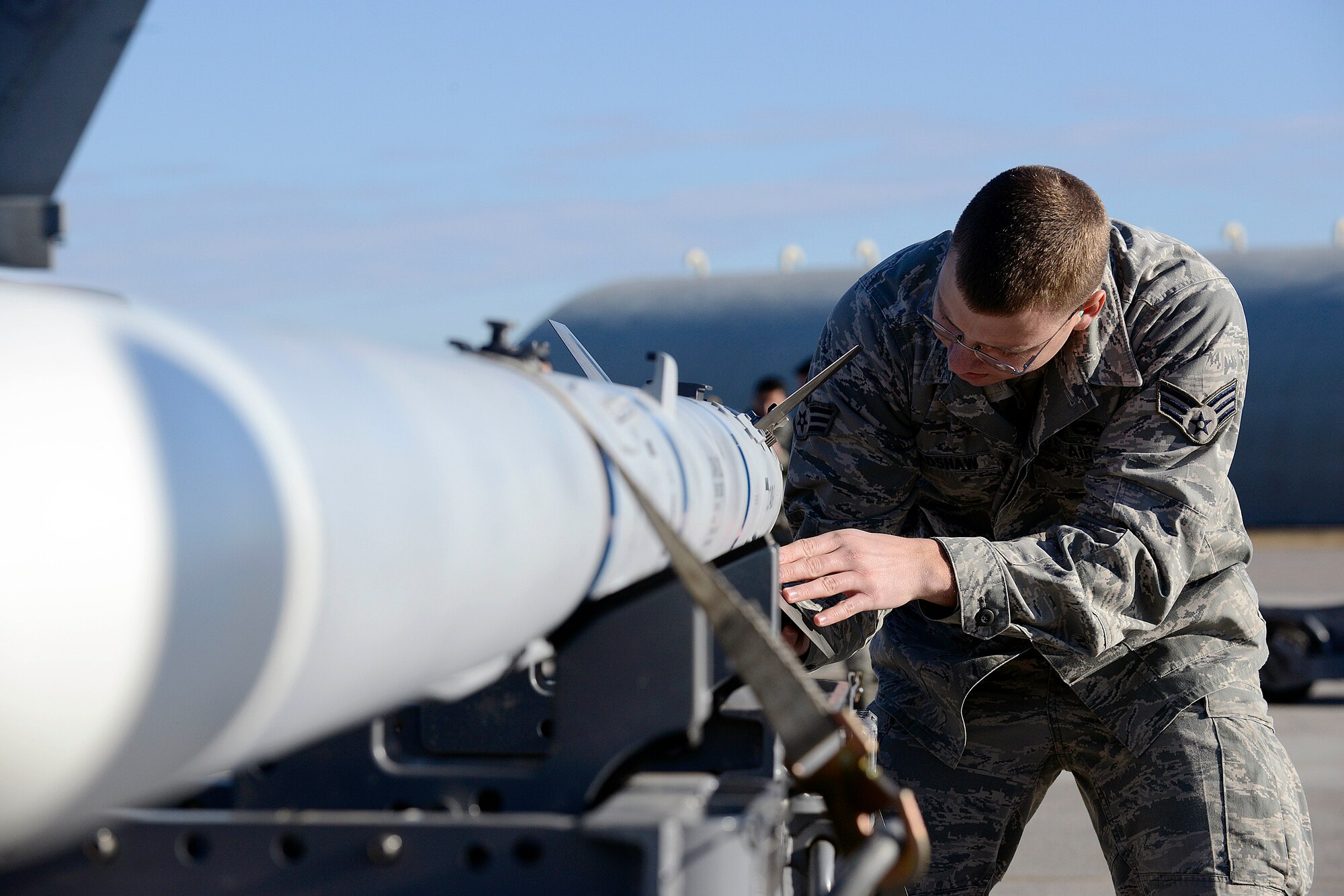 U.S. Air Force Senior Airman Jarrett Bradshaw, 31st Aircraft Maintenance Squadron weapons load crew member, inspects a training munition during a quarterly weapons load competition, Jan. 6, 2015 at Aviano Air Base, Italy. Load crews from the 31 AMXS competed for the base’s top weapon loading honors during the event. (U.S. Air Force photo/Airman 1st Class Ryan Conroy)