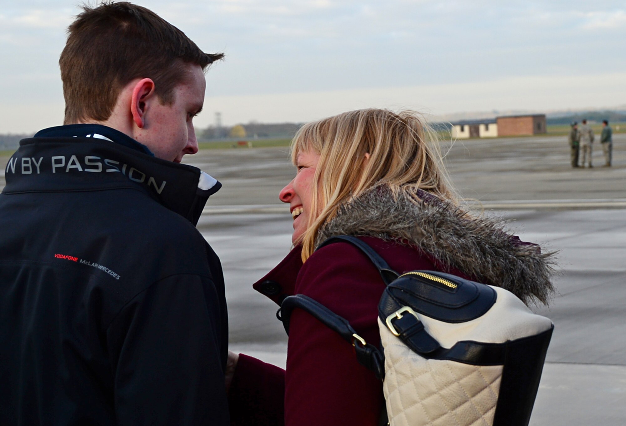 Liam Buckley, 22-years-old, waits for an aircraft approach on the flightline with his mother, Janet Buckley, at Royal Air Force Lakenheath, England, Dec. 30, 2014. Buckley participated in the Pilot for a Day program where he engaged with pilots and observed various aircraft during his visit. (U.S. Air Force photo by Senior Airman Erin O’Shea/Released) 