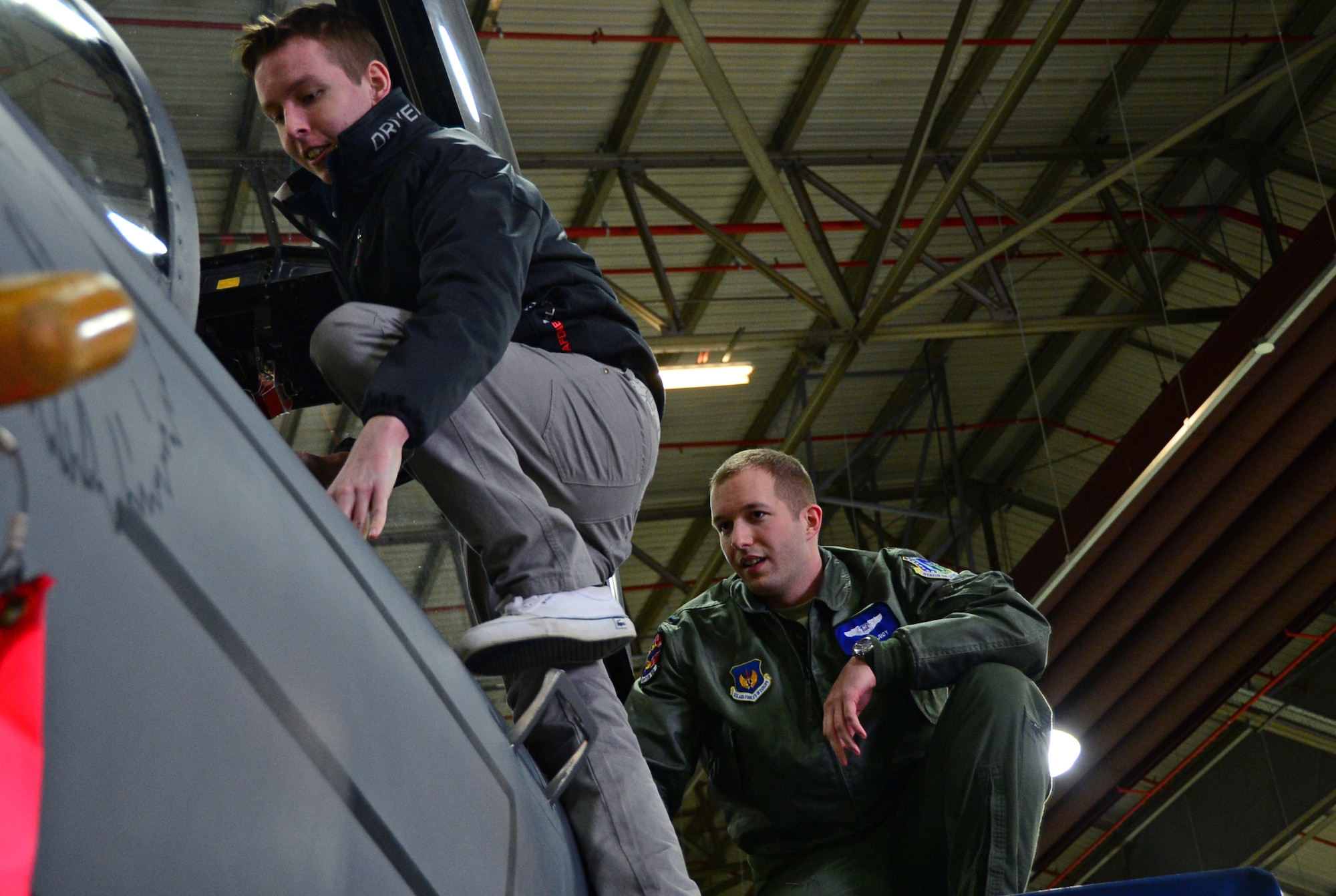 Liam Buckley, a 22-year-old British local from Sheffield, climbs into a 492nd Fighter Squadron F-15E Strike Eagle assisted by pilot 1st Lt. Joshua Judy at Royal Air Force Lakenheath, England, Dec. 30, 2014. Buckley viewed the aircraft during the Pilot for a Day program, which allows children with serious illnesses to experience the life of an Air Force pilot for the day. (U.S. Air Force photo by Senior Airman Erin O’Shea/Released) 
