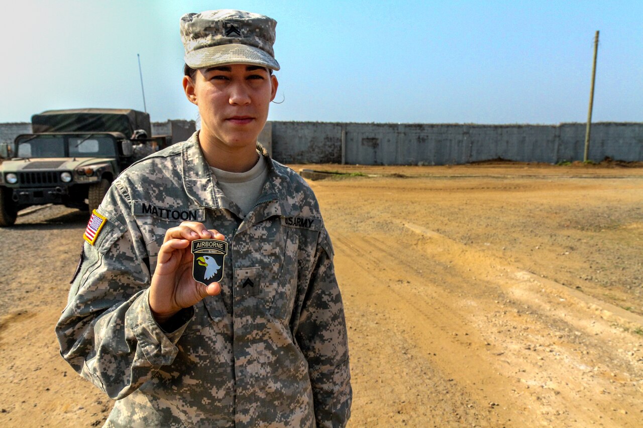 Army Cpl. Nicole Mattoon shows off the coin she received from Army Maj. Gen. Volesky, commander of Joint Forces Command United Assistance, after she was recognized as the service member of the week at the Barclay Training Center, Monrovia, Liberia, Jan. 2, 2015. U.S. Army photo by Spc. Caitlyn Byrne