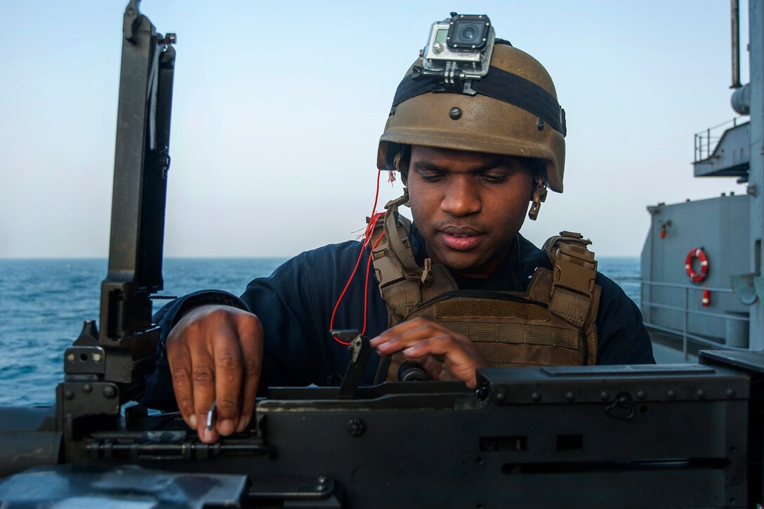 U.S. Navy Petty Officer 2nd Class Anthony Crutchfield checks the head space and timing on an M2HB .50-caliber machine gun on the fantail of the aircraft carrier USS Carl Vinson in the U.S. 5th Fleet area of responsibility, Jan. 5, 2015. Crutchfield is a gunner’s mate.
