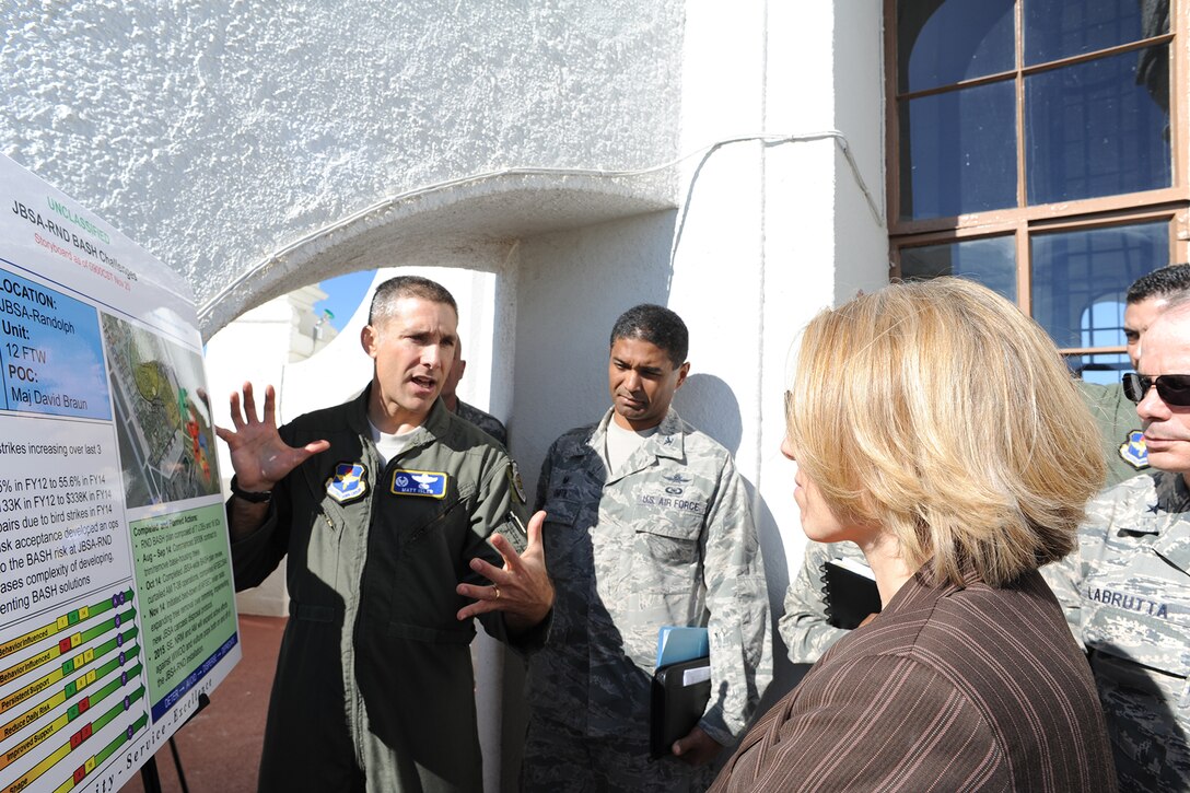 Col. Matthew Isler (left), 12th Flying Training Wing commander, briefs Miranda Ballentine (right), Assistant Secretary of the Air Force for Installations, Environment and Energy, on the increase in bird aircraft strike hazard and ongoing mitigation efforts taken by the wing Dec. 15 at Joint Base San Antonio-Randolph. Col. Alexander Smith (center), 502nd Installation Support Group commander, was also part of the tour group. (U.S. Air Force photo by Melissa Peterson)