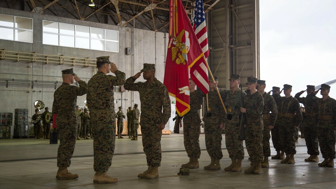 Sgt. Maj. Devon A. Lee, center, salutes Lt. Col. Larry G. Brown and Sgt. Maj. Timonthy J. Rudd during a post and relief ceremony Jan. 8 at hangar 525 on Marine Corps Air Station Futenma, Okinawa, Japan. . Sgt. Maj. Devon A. Lee passes on his reponsibilities as the squadron sergeant major to Sgt. Maj. Timonthy J. Rudd. Marines are with Marine Medium Tiltrotor Squadron 262, 31st Marine Expeditionary Unit. 