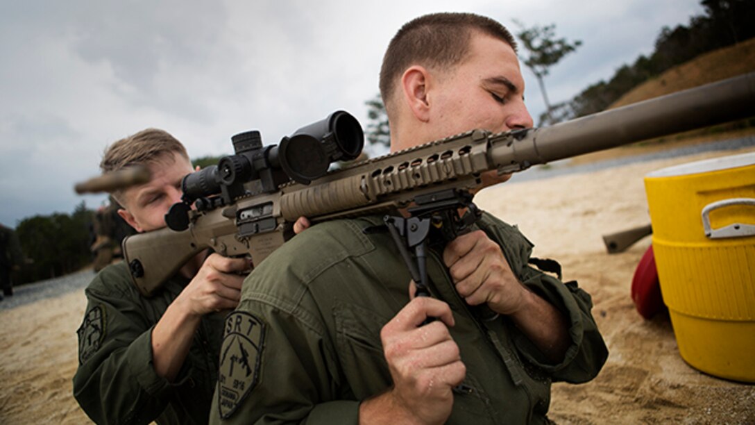 Lance Cpl. Christian Christopoulos (back) and Cpl. Tyler Stampes fire an M110 semi-automatic sniper system in an improvised firing position during marksmanship/observer training at Range 22 Jan. 6. The Marines are with Special Reaction Team, Camp Foster Provost Marshal’s Office, Marine Corps Installations Pacific - Marine Corps Base Camp Butler. Christopoulos is a Parker, Colo., native and Stampes is a Bakersfield, Calif., native. SRT is the military equivalent of Special Weapons and Tactics teams. (U.S. Marine Corps photo by Sgt. Matthew Callahan/Released)