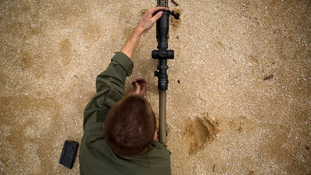 Cpl. Tyler Stampes gets in the prone position behind his M110 semi-automatic sniper system during marksmanship/observer training Jan. 6, at Range 22. Stampes is with the Special Reaction Team, Camp Foster Provost Marshal's Office, Marine Corps Installations Pacific - Marine Corps Base Camp Butler and a Bakersfield, Calif., native. SRT is the military equivalent of Special Weapons and Tactics teams. (U.S. Marine Corps Photo by Cpl. Matthew Callahan/Released)