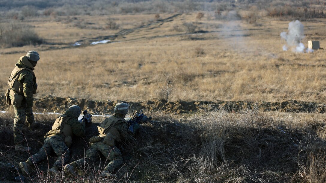Two Black Sea Rotational Force Marines, firing 40mm high explosive rounds, attempt to hit barriers in a sequence during the Weapons Co., 2nd Battalion, 2nd Marines company exercise. The Marines are training hard through cold weather conditions and high winds at Novo Selo Training Area, Bulgaria. 