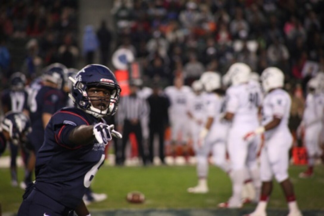 Semper Fidelis All-American Bowl Team East wide receiver Tristan Payton, a Jacksonville, Fla., native, checks with the line judge Jan. 4, 2015, at The StubHub Center in Carson, Calif. The bowl brings selected players like Payton, a First Coast High School student committed to playing at University of Southern California, together with Marines and football coaches to develop skills not only important to football, but throughout life, such as leadership, self-confidence and teamwork. (U.S. Marine Corps photo by Sgt. Erik S. Brooks Jr.)