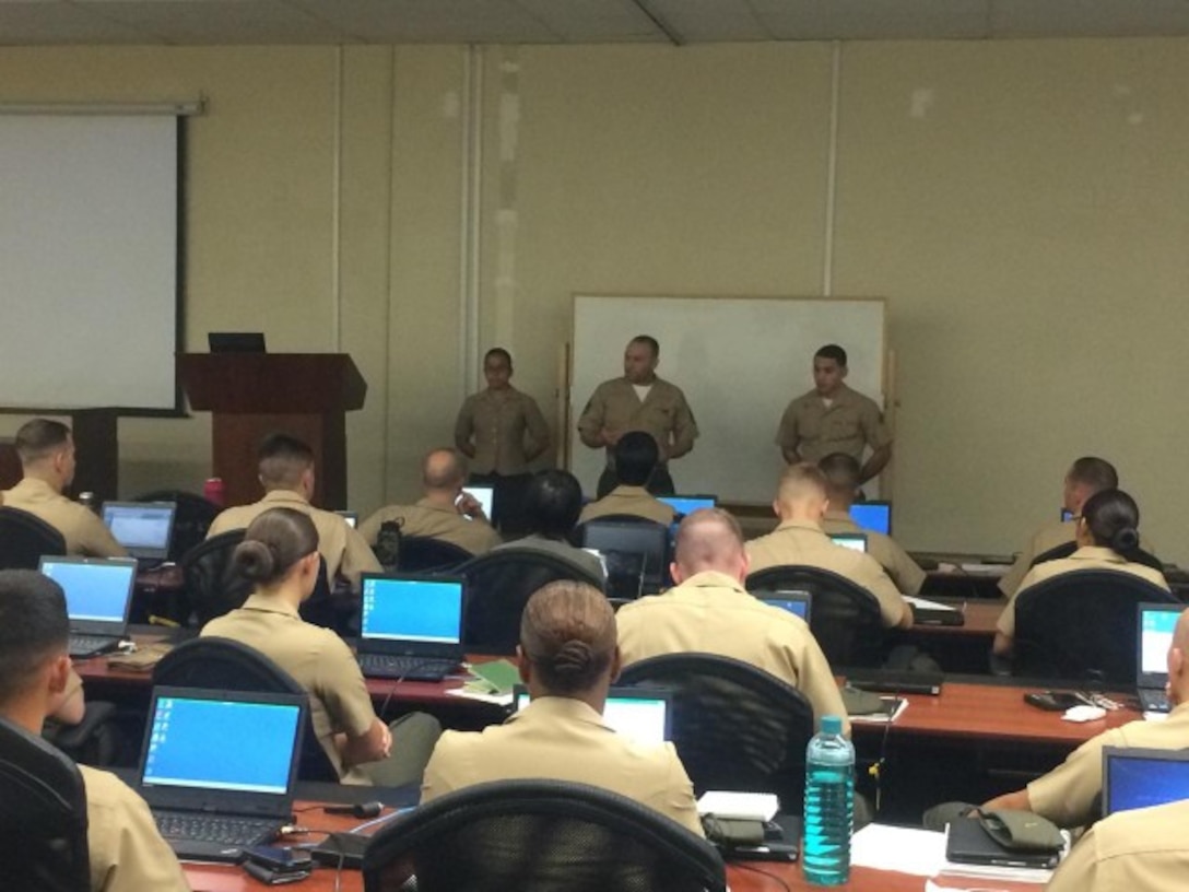 MCCES Admin SNCOIC SSgt Bayron A. Vanegas and MCCES Admin Clerks Cpl Henry B. Medina and PFC Stephanie N. Donayre are giving an admin brief to the first Basic Communications Officer Course to go through Delta Company. 