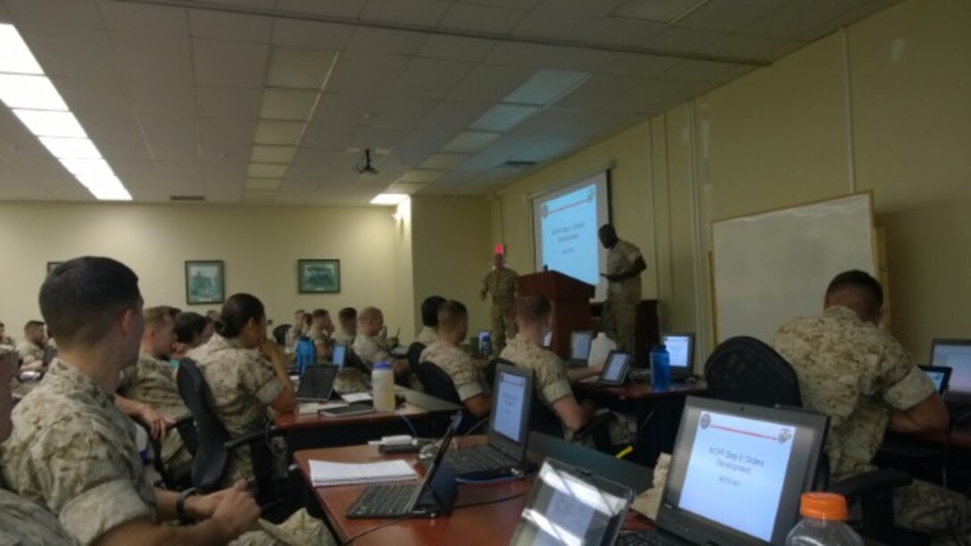 2ndLt Zhi Chen's poetry as an attention gainer during the Basic Communications Course's MCPP Transition class, Delta Company, Communications School. All students are observing enthusiastically as Lt Chen demonstrates the steps in MCPP while including rhythmic motions.