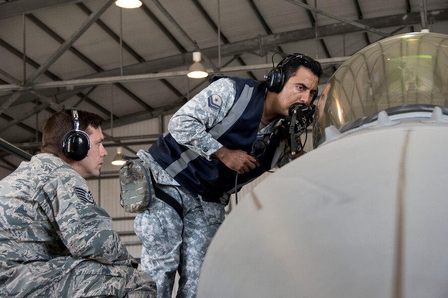 U.S. Air Force Tech. Sgt. Jeffrey Kelley, left, observes while members of the Chilean air force perform preflight functions checks Dec. 3, 2014, in Chile. During the four-week training session, which took place in Chile and focused on perfecting maintenance procedures and the use of night vision goggles, 12th Air Force (Air Forces Southern) members were able to successfully meet all training objectives while establishing a very strong partnership. Kelley is a 372nd Training Squadron Detachment 12 F-16 avionics instructor. (U.S. Air Force photo/Staff Sgt. Adam Grant)