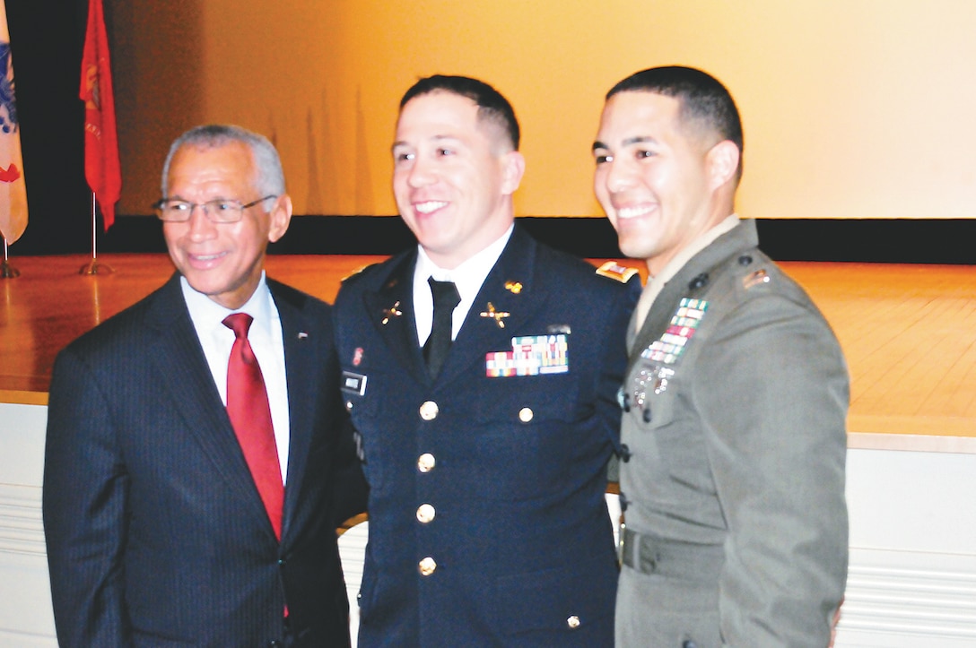 Expeditionary Warfare School students, Army Capt. Robert White and Capt. Gabriel Algarin, pose with NASA Adminstrator Charles F. Bolden Jr. following his speech at Little Hall on Dec. 16.