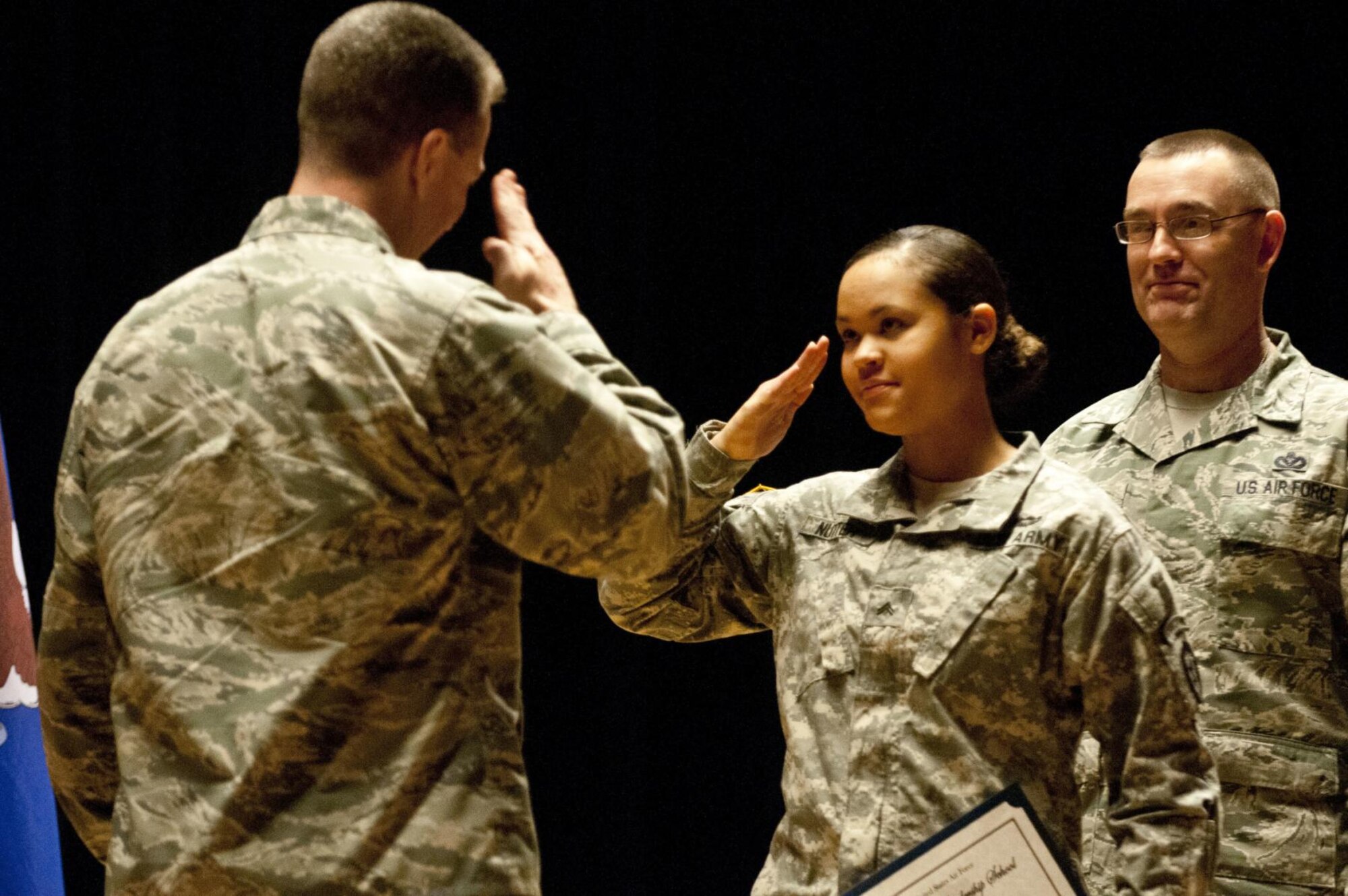U.S. Army Cpl. Janay Nutter salutes Col. Brian Bruckbauer, the commander of 673rd Air Base Wing, during the Airman Leadership Course class 15-1 graduation in the post theater Dec. 18, 2014, at Joint Base Elmendorf-Richardson, Alaska. Nutter is a radio retransmission squad leader with 2nd Platoon, C. Company, 6th Brigade Engineer Battalion, 4th Infantry Brigade Combat Team (Airborne), 25th Infantry Division. (U.S. Army photo/Staff Sgt. Daniel Love)