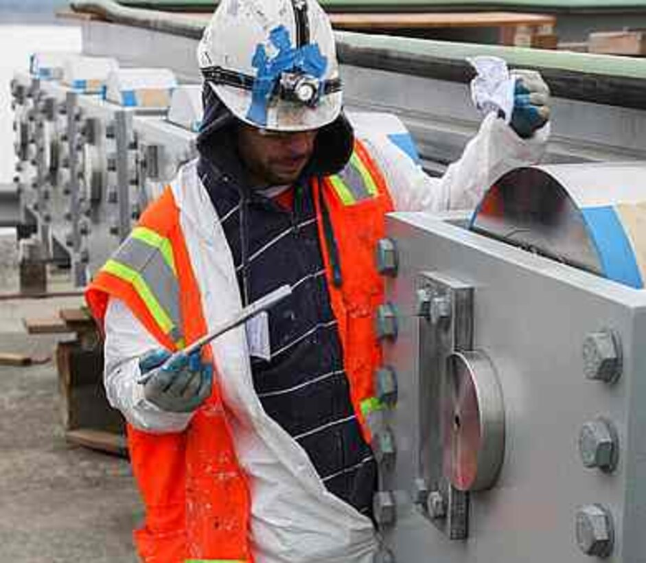 A contractor applies some final touches to a bulkhead gate for the Folsom Dam auxiliary spillway's control structure in Folsom, California, Dec. 29, 2014.  The first of six bulkhead gates is scheduled to be installed in mid-January. The U.S. Army Corps of Engineers Sacramento District, together with the U.S. Bureau of Reclamation and state and local partners, is building the spillway to reduce flood risk throughout the Sacramento region. 