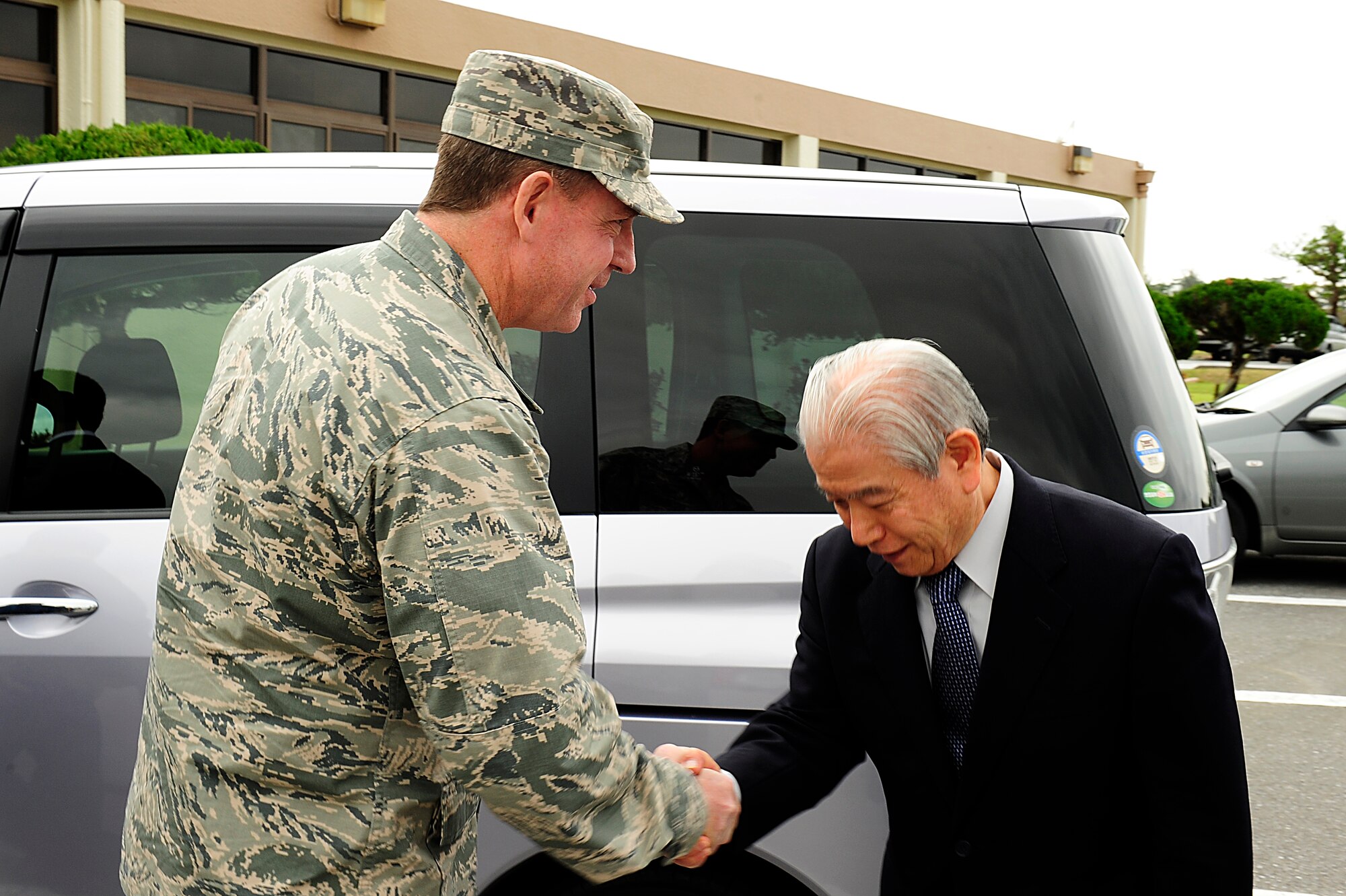 U.S. Air Force Brig. Gen. James Hecker, 18th Wing commander, meets with Kiyoshi Ikehara, Okinawa Chamber of Commerce managing director, during a visit on Kadena Air Base, Japan, Jan. 7, 2015. As part of Japanese tradition, local public office officials visit business-affiliated organizations and personnel at the beginning of each new year to wish them a happy and prosperous year. (U.S. Air Force photo by Senior Airman Maeson L. Elleman)