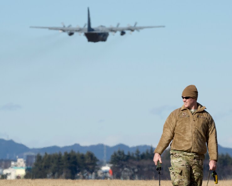 Tech. Sgt. Bruce Rick, 31st Rescue Squadron NCO in charge of combat arms, observes a C-130 Hercules takeoff at Yokota Air Base, Japan, Jan. 7, 2015. The 36th Airlift Squadron and 31st Rescue Squadron maintain mission readiness for aircrew and pararescuemen. (U.S. Air Force photo by Osakabe Yasuo/Released) 