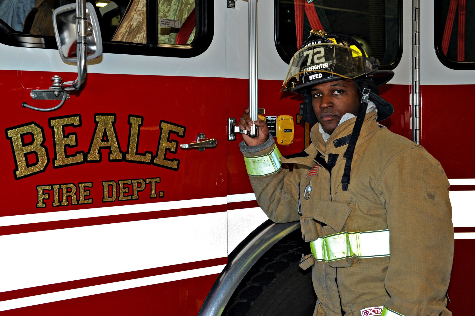 Airman 1st Class Michael Reed, 9th Civil Engineer Squadron firefighter, poses in front of a fire engine at Beale Air Force Base, Calif., Jan. 8, 2014.  (U.S. Air Force photo by Airman 1st Class Ramon A. Adelan/Released)