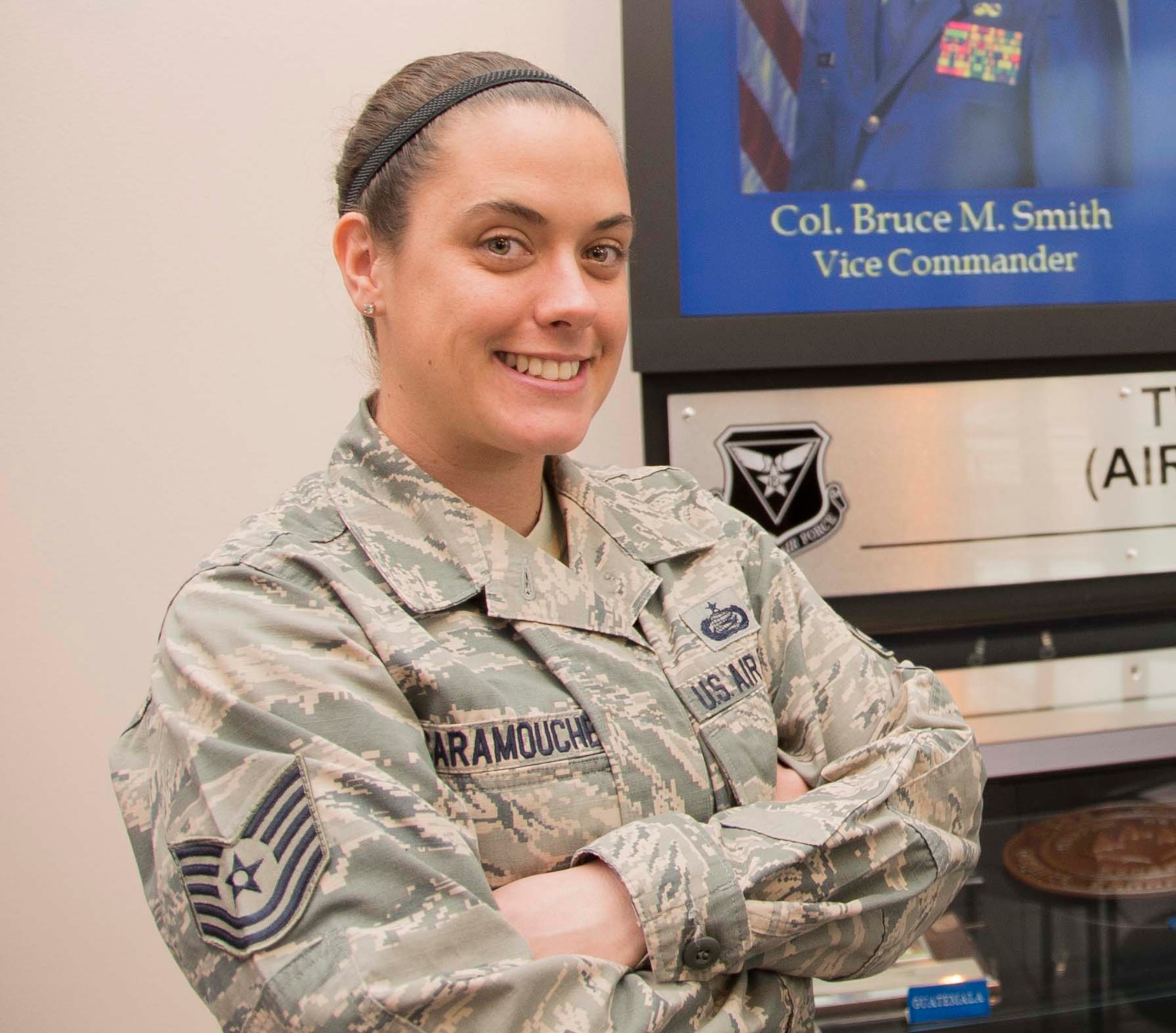 Tech Sgt. Diana Scaramouche, 12th Air Force (Air Forces Southern) Command Chief Executive Assistant, smiles before going around and engaging with other noncommissioned officers on Jan. 08, 2014 at Davis-Monthan AFB, Ariz. Some of her day-to-day duties include coordinating or researching a multitude of taskers involving the enlisted force at the eight wings and one direct reporting unit that fall under 12 Air Force (Air Forces Southern). (U.S. Air Force photo by Staff Sgt. Adam Grant/Released)
