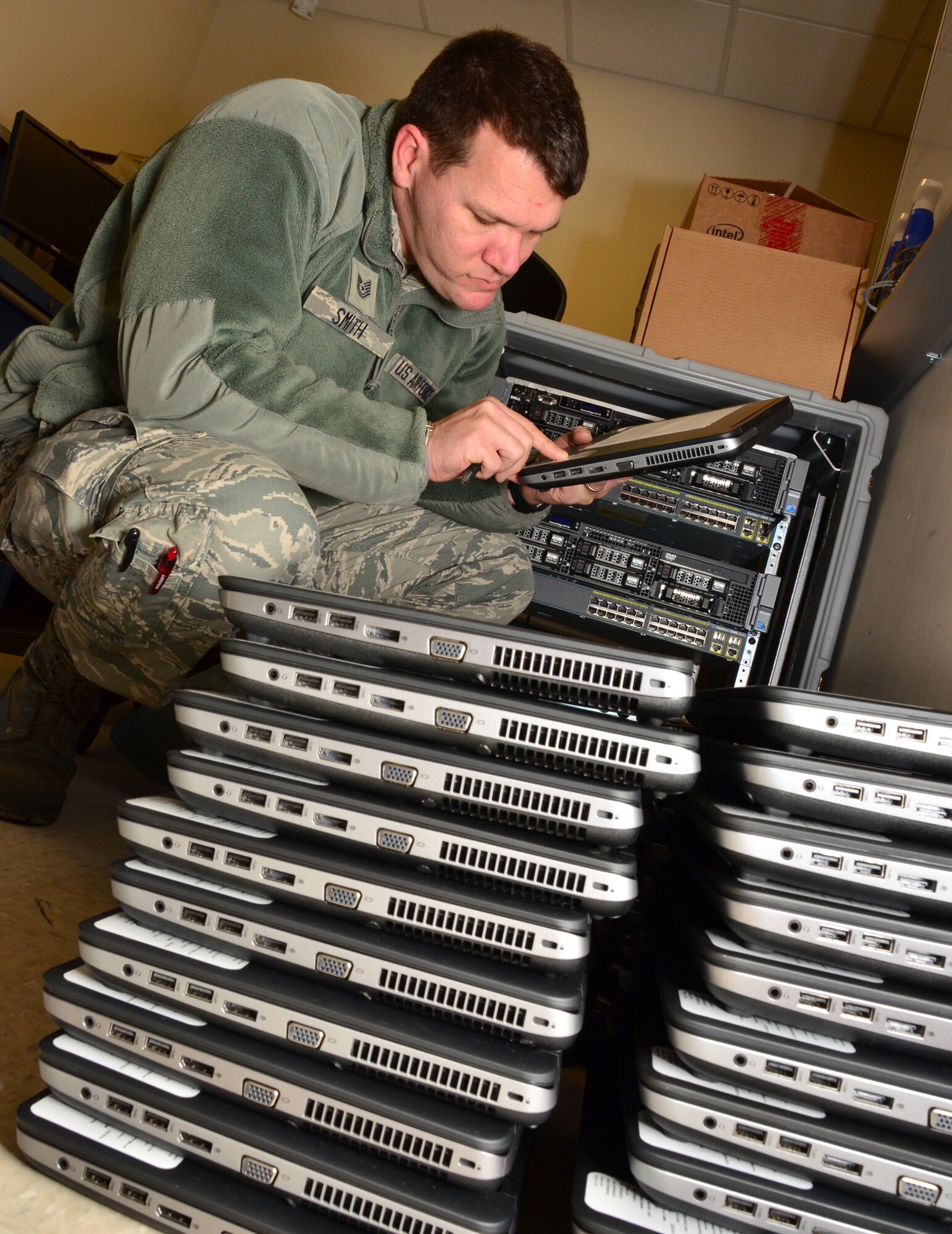 Tech Sgt. Joshua Smith, an information technology specialist with the 403rd Communications Flight at Keesler Air Force Base, inventories and take accountability of a new batch of tech refresh laptops. (U.S. Air Force Photo/Master Sgt. Brian Lamar)