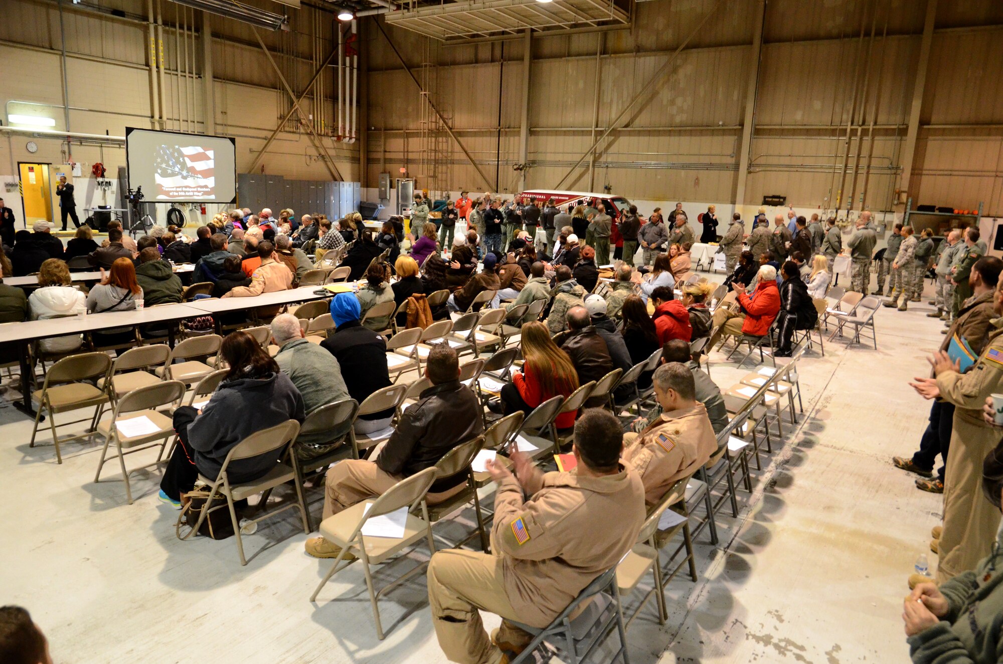 Team Dobbins members wait for lunch to be served during a deployment ceremony Jan. 8, 2015 at Dobbins Air Reserve Base, Ga. More than 150 members from the 94th Airlift Wing deployed to support the Central Command Area of Responsibility. (U.S. Air Force photo/Brad Fallin)