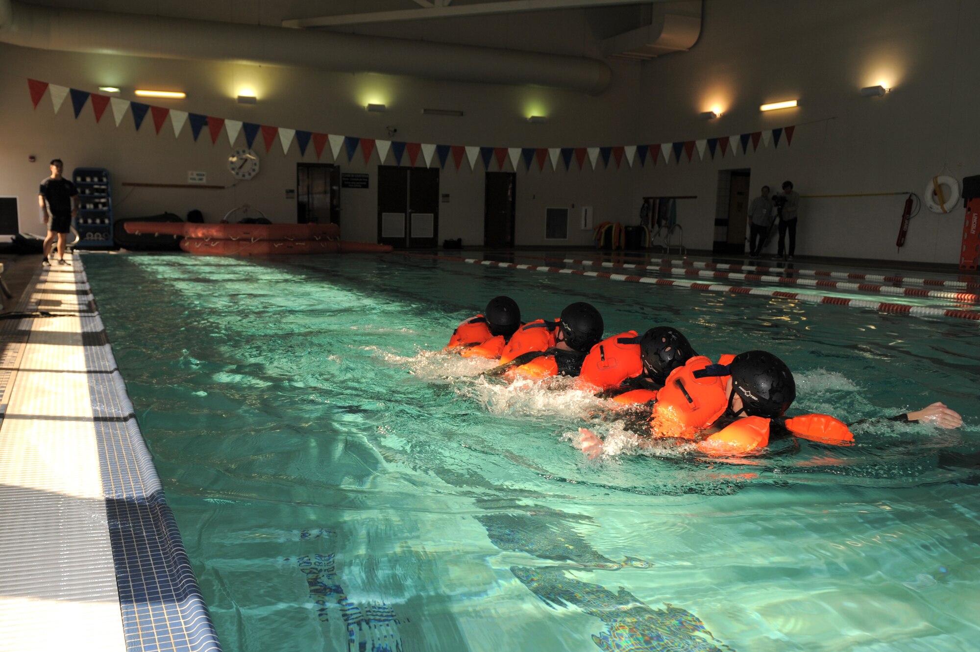 U.S. Air Force Airmen backstroke as a unit during a water survival training refresher course at Davis-Monthan Air Force Base, Ariz., Jan. 5, 2015. The group activity focused on getting aircrew members accustomed to working together while in water so they are able to preserve energy in the event of a ditched aircraft. (U.S. Air Force photo by Airman 1st Class Chris Drzazgowski/Released)