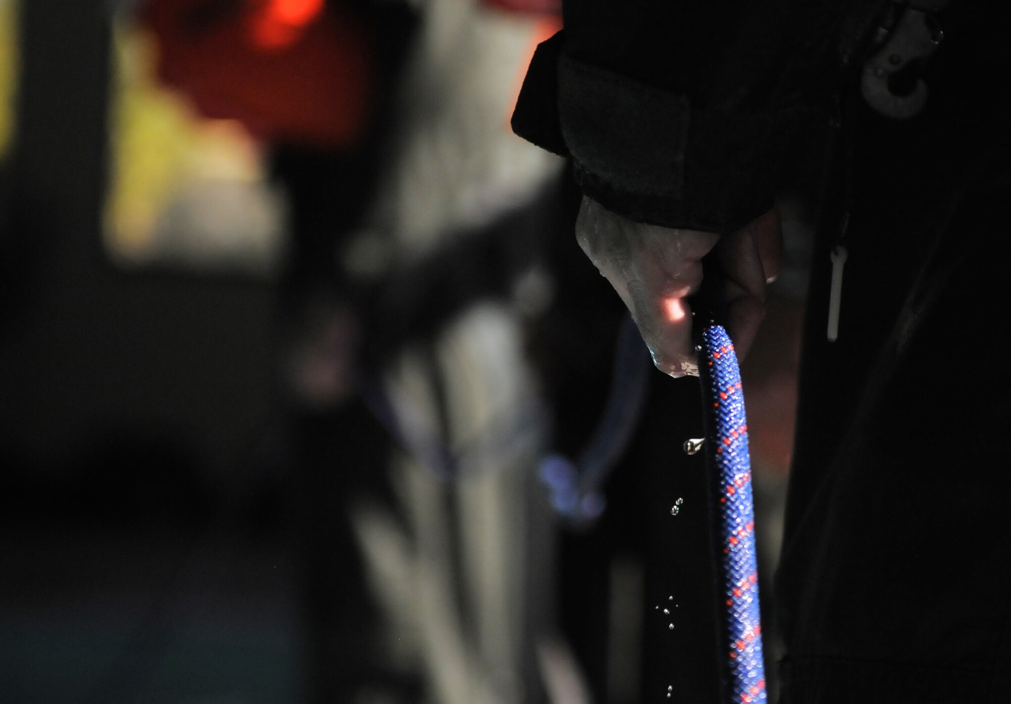 U.S. Air Force Tech. Sgt. Brent Reynertson, 55th Electronic Combat Group evaluator and mission crew supervisor, prepares to drag another Airman through the water during a water survival training refresher course at Davis-Monthan Air Force Base, Ariz., Jan. 5, 2015. The drag simulates the moments an aircrew member experiences after landing in the water with a deployed parachute. (U.S. Air Force photo by Airman 1st Class Chris Drzazgowski/Released) 