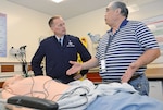 Thomas Kai (right), Graduate Medical Education coordinator for simulation, explains to Brig. Gen. James McClain, Air Force Medical Support Agency commander, the advanced capabilities of simulation training dummies and scenarios that were available to students; during his visit Dec. 8, 2014, at the San Antonio Military Medical Center, Joint Base San Antonio-Fort Sam Houston.
Photo by Air Force Staff Sgt. Christopher Carwile 