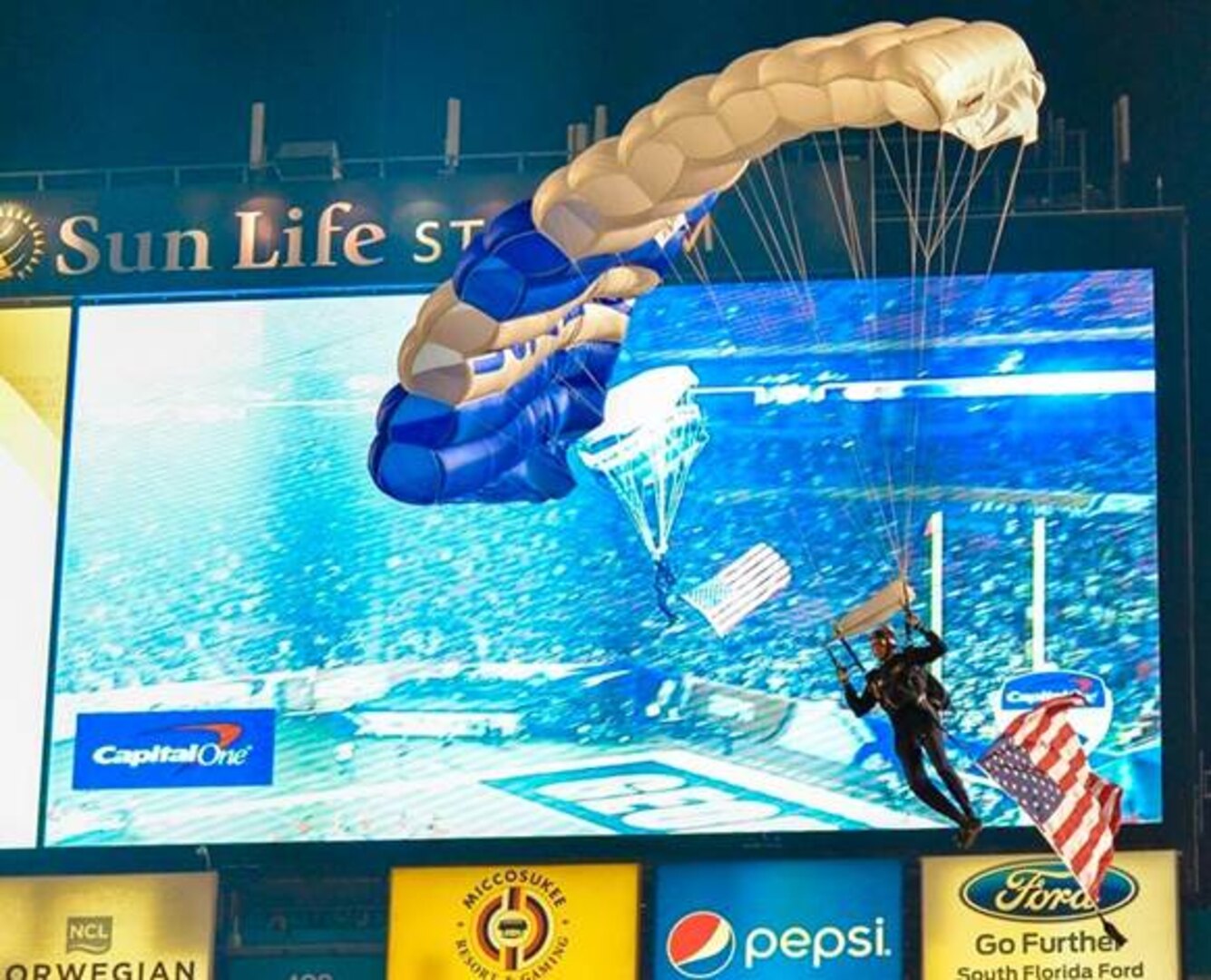 A U.S. Air Force Academy Wings of Blue demonstration team cadet drops into the Orange Bowl Dec. 31, 2014, at Sun Life Stadium in Miami. The Wings of Blue parachute teams were busy training, competing and taking part in a variety
of parachute demonstrations across the country during the holiday season. (Courtesy photo)